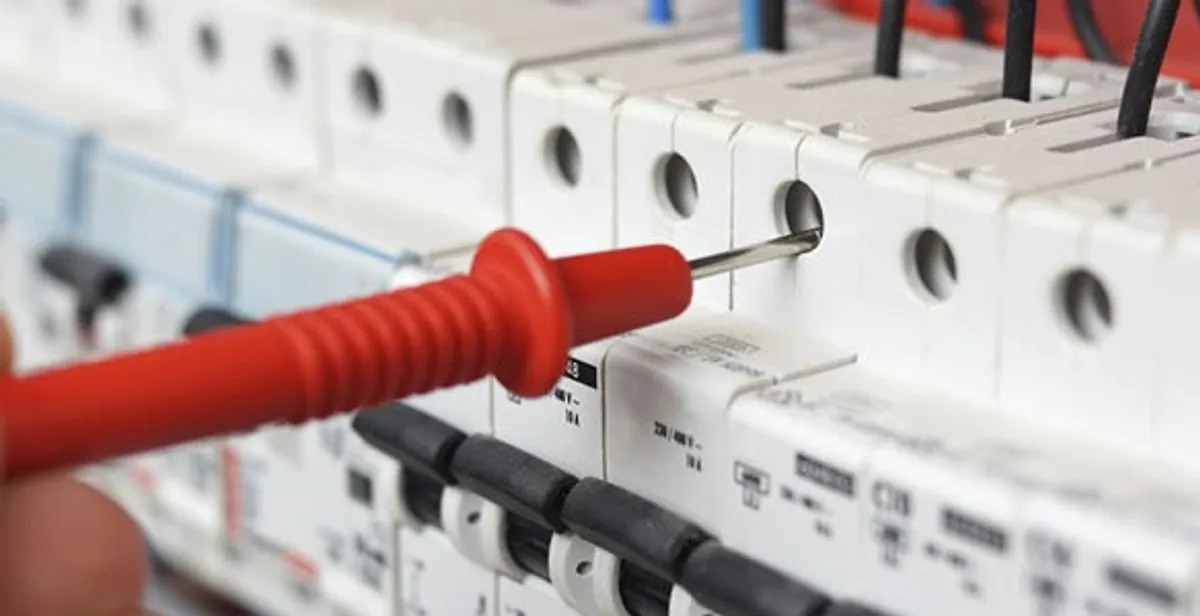 Electrical contractor testing circuit breakers during electrical repair in Adkins, TX