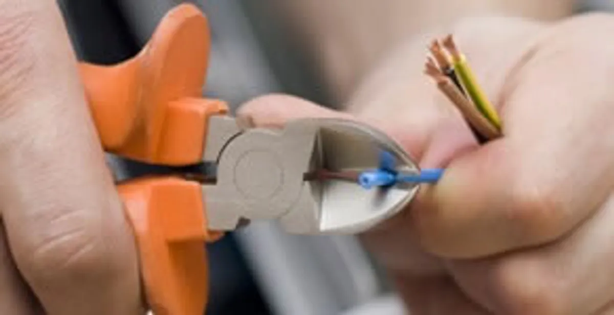 professional electrical services showing precise wire cutting by licensed electricians in San Antonio, TX